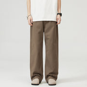Person wearing brown wide-leg  Japanese Chino Pants on a white background