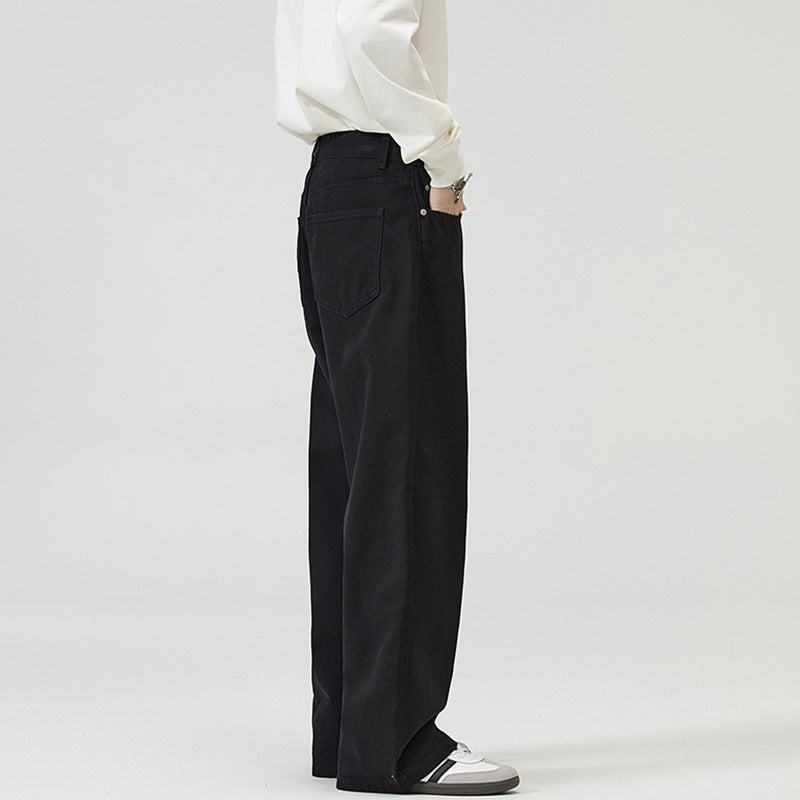 Person wearing black Japanese Chino Pants and a white shirt on a plain background