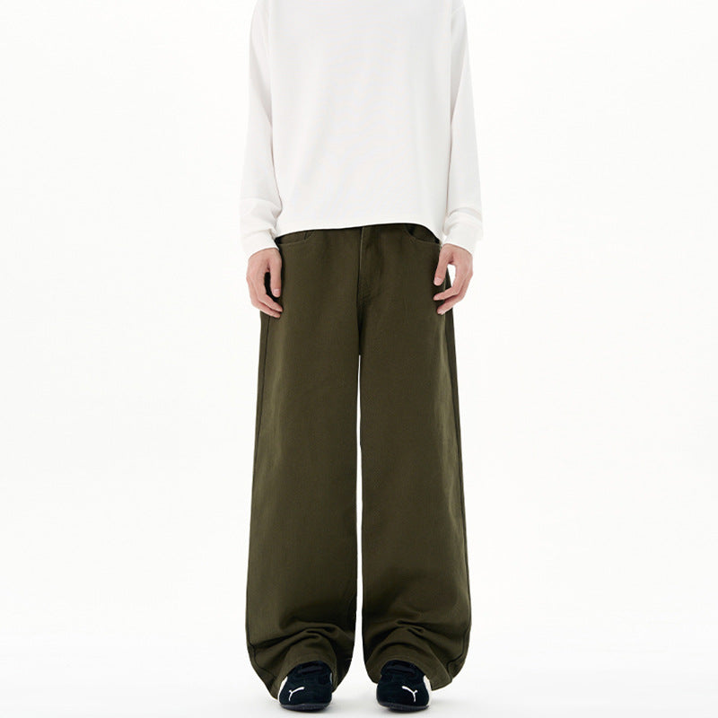 Person wearing olive green wide-leg Japanese Chino Pants and a white top on a white background