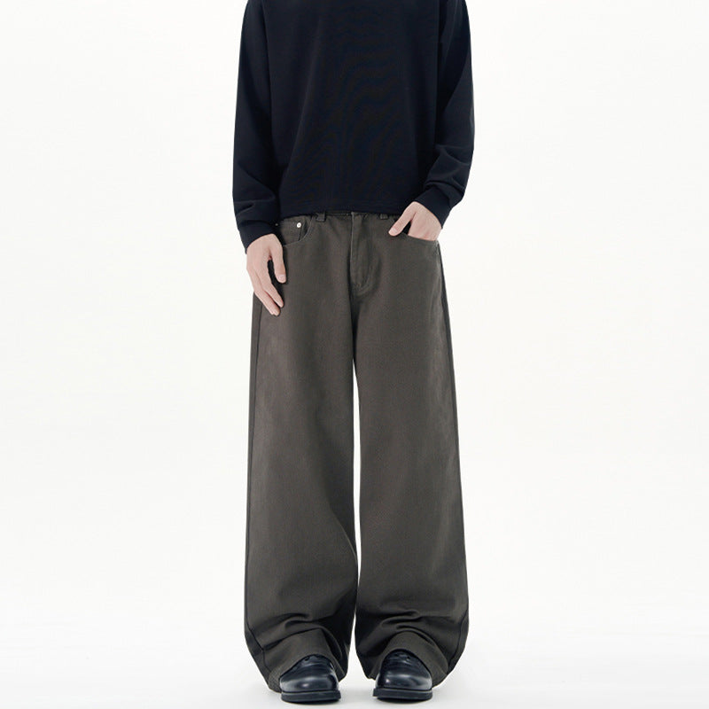 Person wearing a dark sweater and gray wide-leg Japanese Chino Pants on a white background