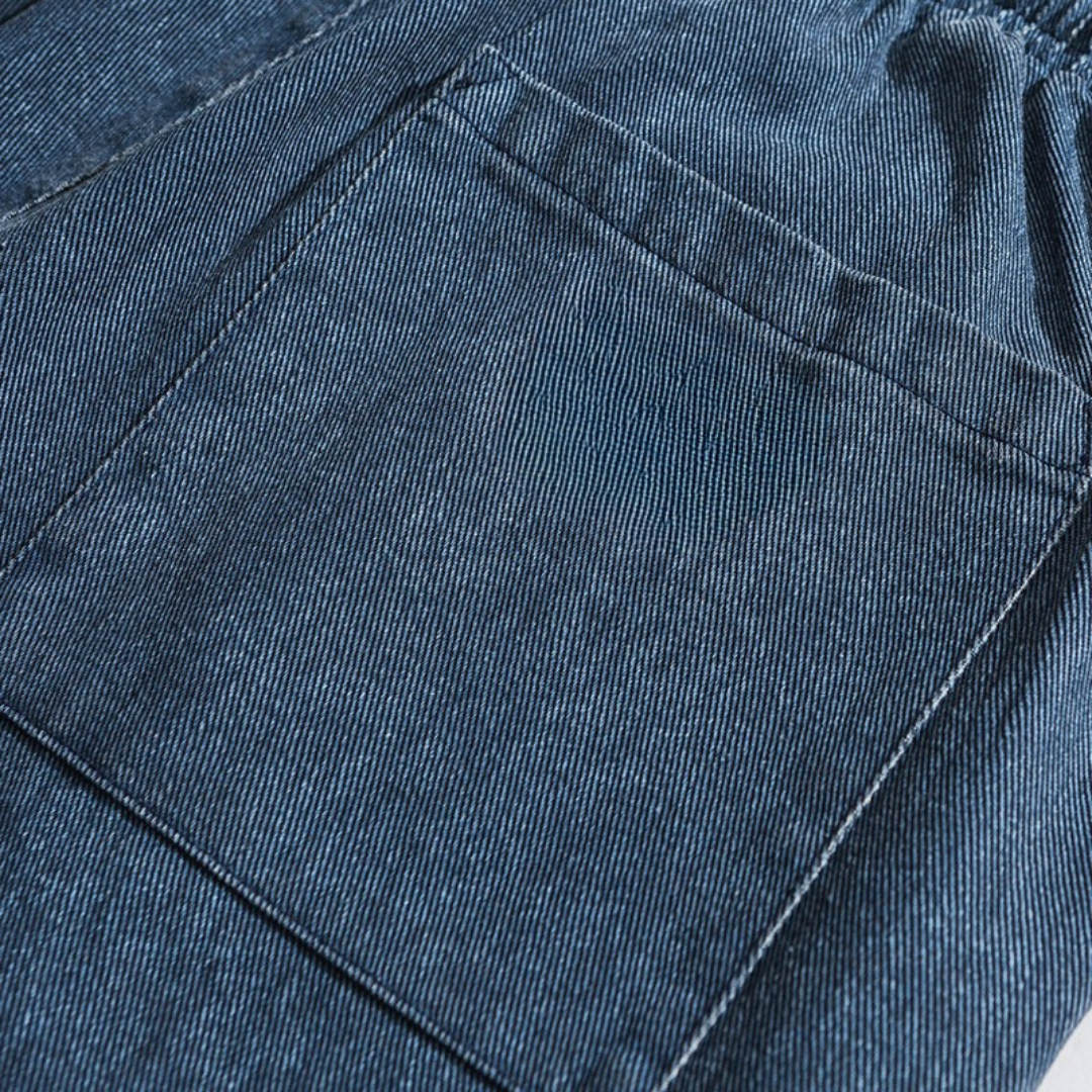 Close-up of blue pokku pants denim fabric with stitching detail