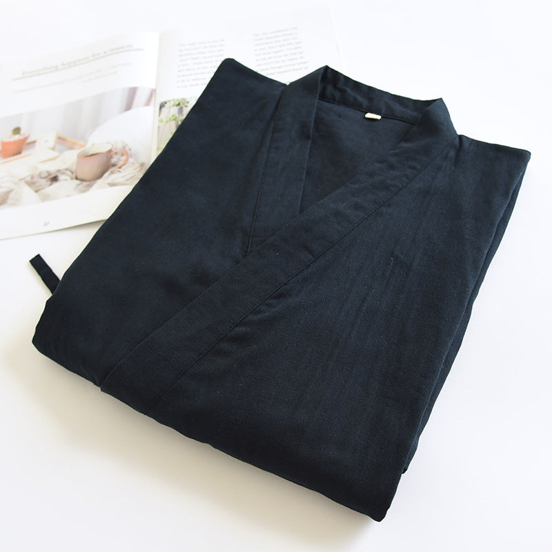 japanese Folded black robe on a light surface