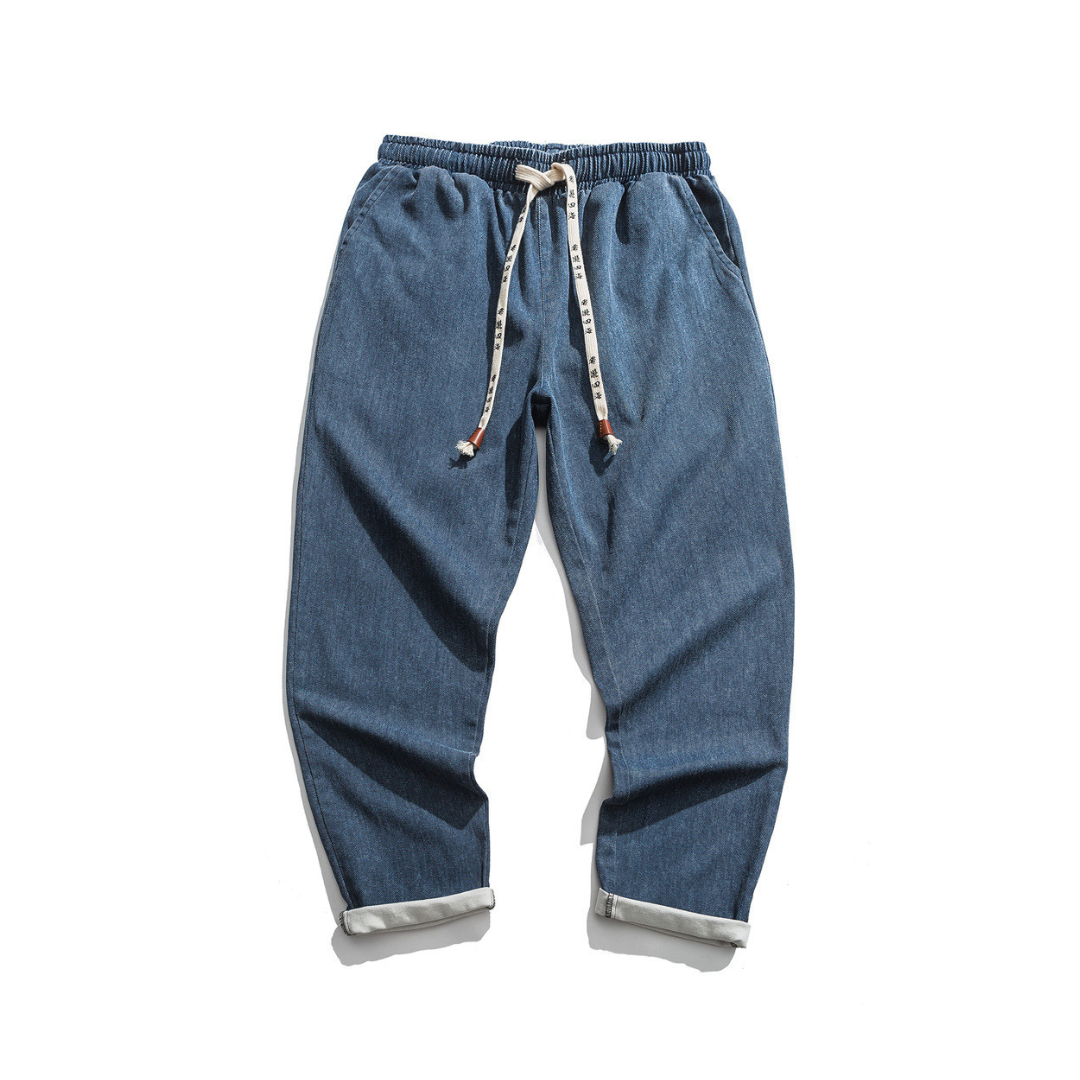 Blue denim pokku pants with drawstring on a white background